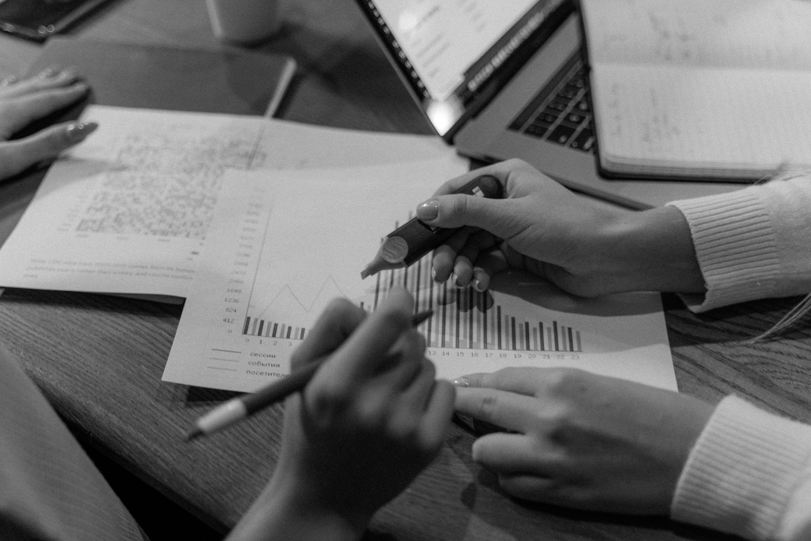 Notes, charts and a laptop on a desk