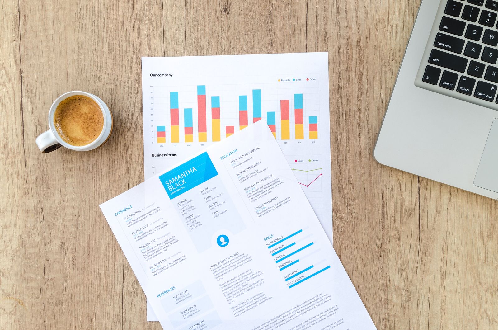 Notes, charts and a laptop on a desk