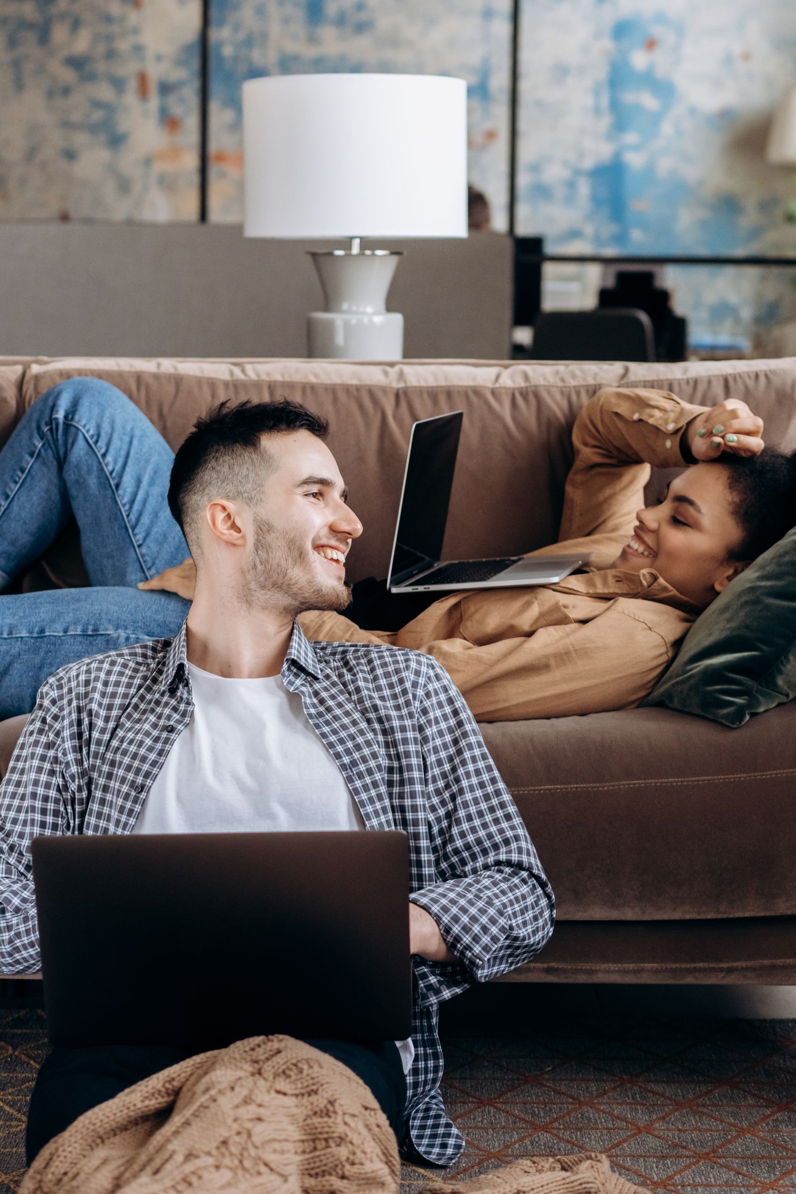 Two colleagues smiling at a laptop
